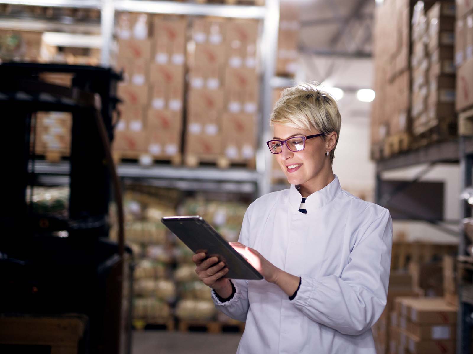 Woman with tablet in warehouse planning capacity
