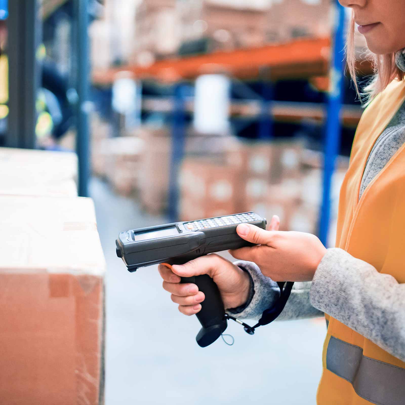 Worker scanning items in a warehouse.